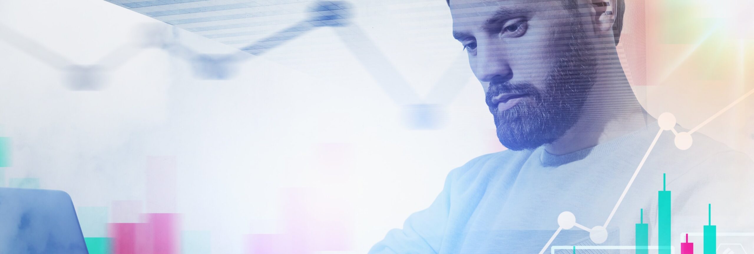 Bearded man in a light sweater looking down at a laptop, with bar charts and a line graph overlaid in a double exposure, illustrating labor market data for capital markets.